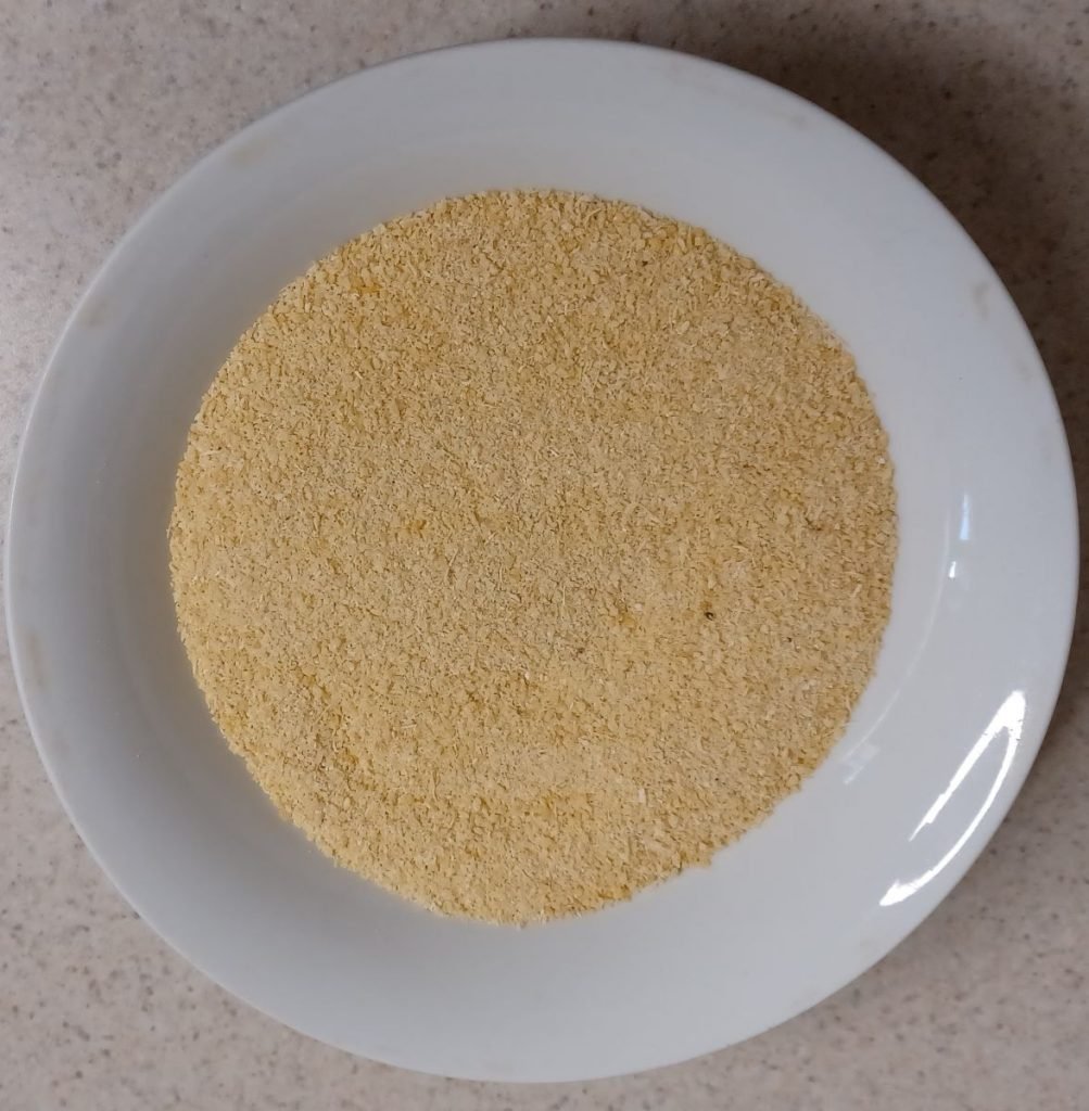 Garri in a white bowl in a white background.