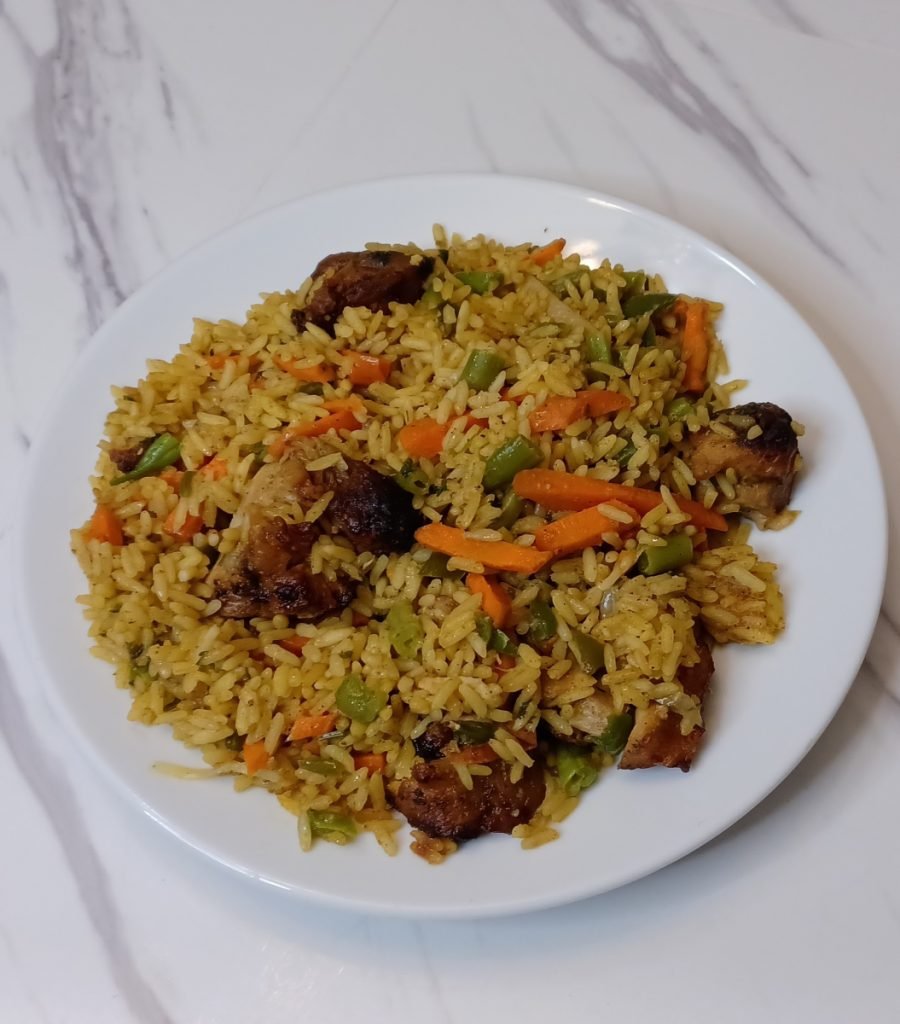Jellof rice in a white dish in a white background.