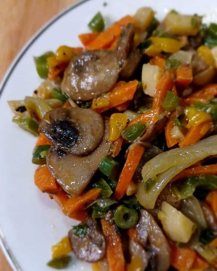 Mushroom stir fry in a white plate.