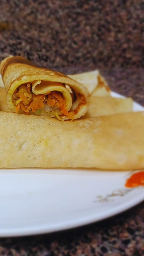 Pancake rolls in a white dish.