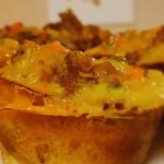 Plantain cupcake meat pie in a white plate.