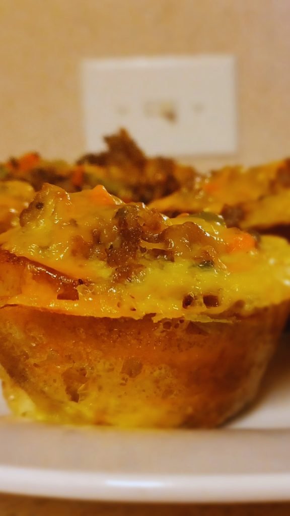 Plantain cupcake meat pie on a white dish.