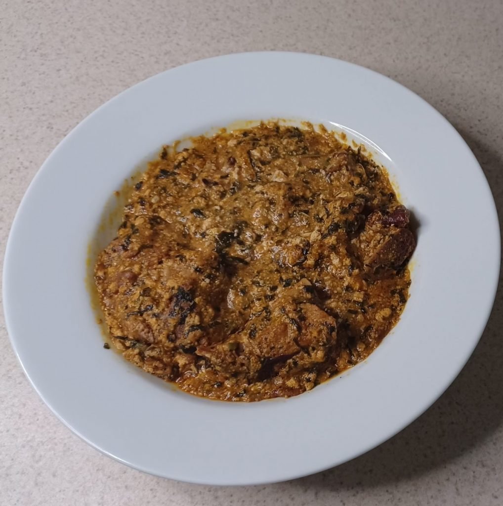 Tanchot soup in a white dish on a white kitchen slab.